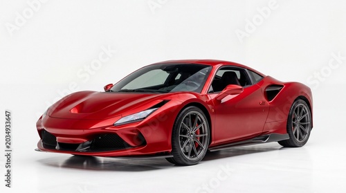 Modern red sports car parked in a studio