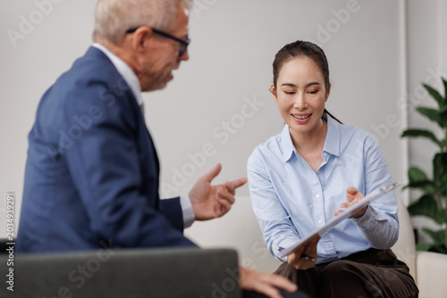 Business people having an advisory meeting, discussing paperwork, collaborating on a project, and consulting with a client in a modern office, planning financial solutions