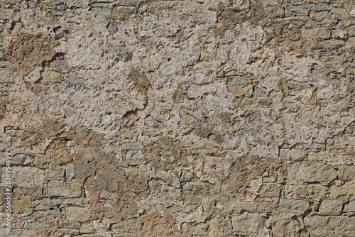 Obraz na plátně Close-up of texture of an old, weathered stone wall, it features a heavily weathered surface with a mix of exposed stones and remnants of crumbling plaster or stucco, Saaremaa, Estonia, Europe