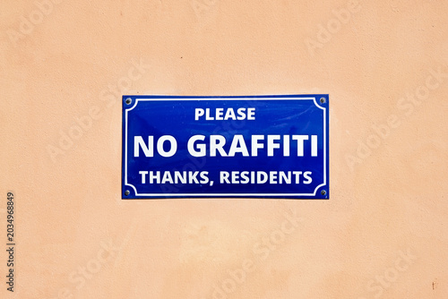 A sign on a Prague wall requests no graffiti on the wall.