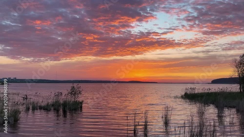 Romantic colorful sunset  over the river. Evening sky. Dramatic sunset. Natural colors.