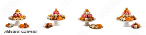 Assortment of traditional indian sweets stacked on cake stands, isolated on transparent background