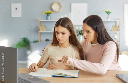 фотографія Attentive loving mother supporting sad teenage daughter in study, together at ho