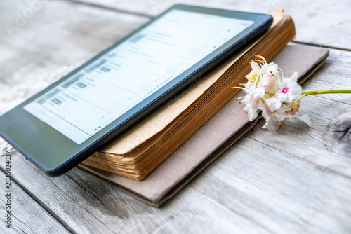 ebook reader on stack old paper books on wooden table, electronic book, digital reading device and vintage literature contrast, technology vs tradition, Back to school and education, blank copy space