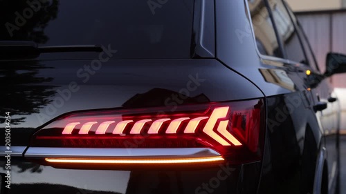 Emergency flashing car rear light lamp. Nobody around to help. Car emergency light signal, warning sign. Rear Red LED Brake Light New Luxury Car.