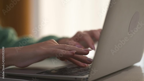 Girl with her hands typing on laptop. woman work from home concept. hands of a woman typing on a laptop. a girl with large hands lifestyle typing on a laptop.