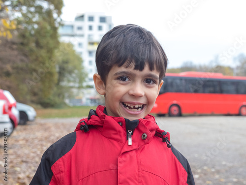 Happy Little Boy Laughing and Smiling Gladly at Camera Outdoors