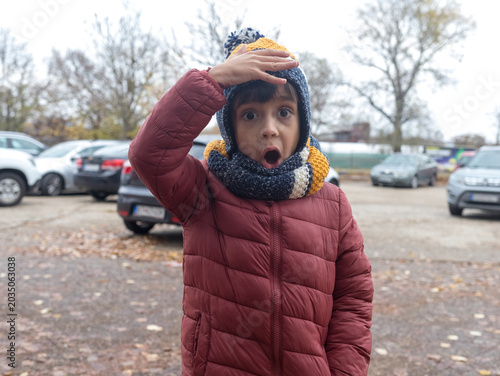 Shocked Little Boy Holding Hand on Head with Open Mouth in Disbelief