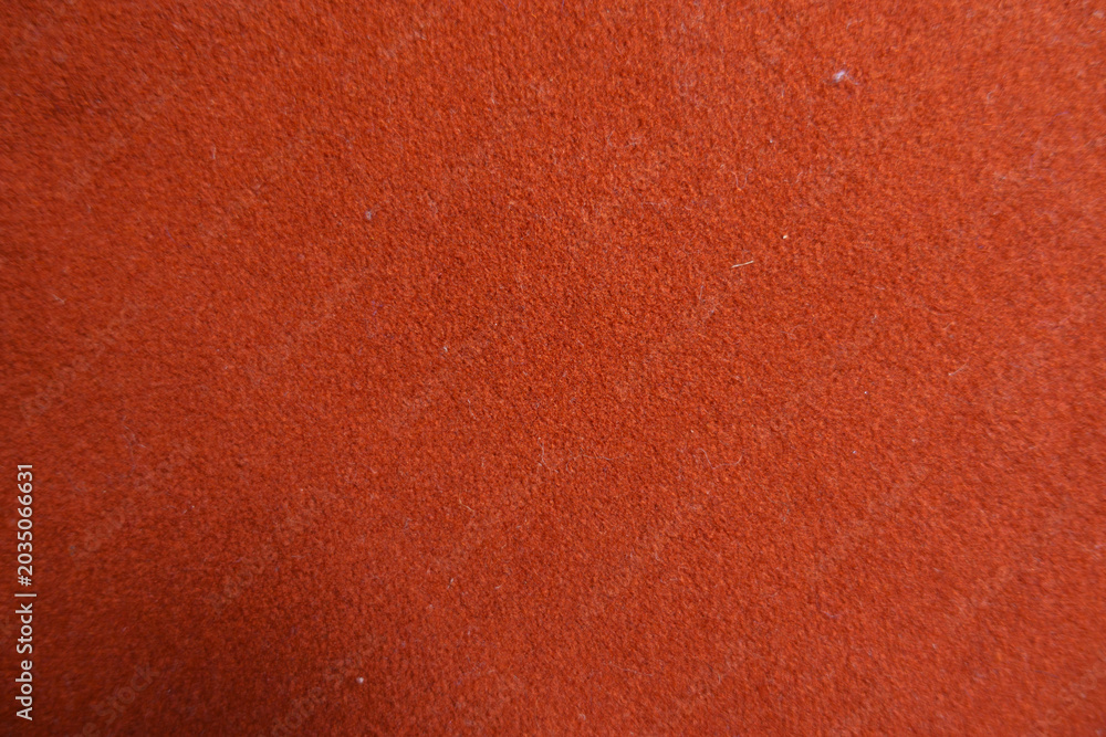 Fototapeta premium Texture of simple reddish orange felt fabric