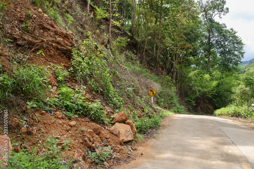 Billede på lærred Steep landslide slope natural disaster erosion danger on rural concrete road edg
