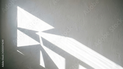 Abstract Geometric Sunlight Shadows and Reflections on Textured White Wall