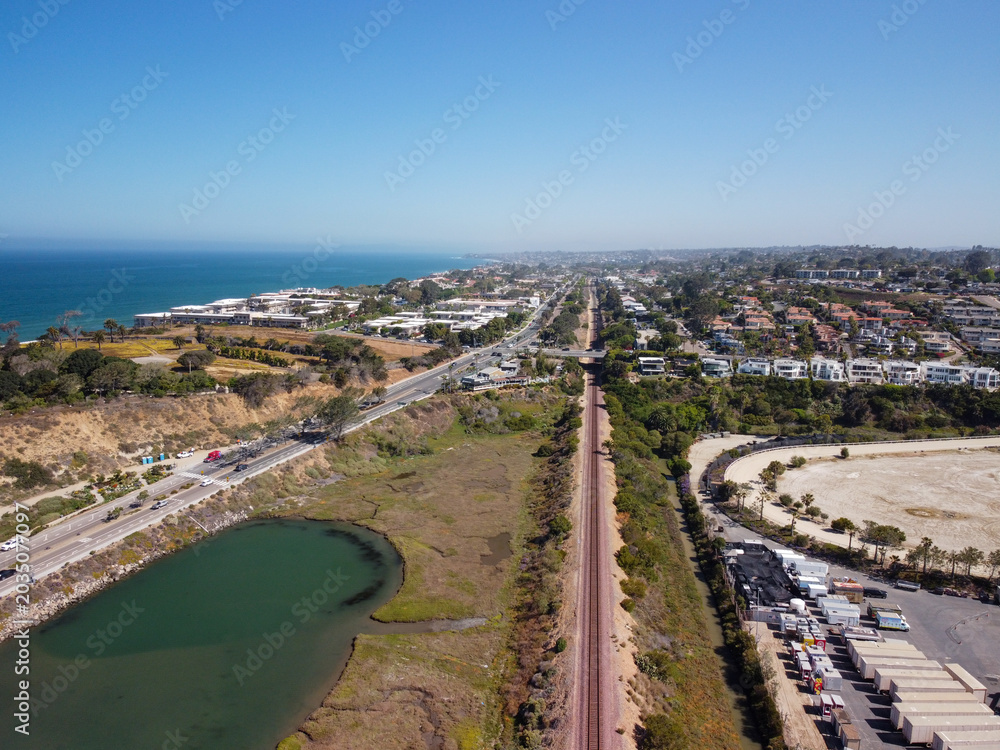 Fototapeta premium Aerial View of Del Mar Coastal Rail Line and Highway 101 Beside San Dieguito Lagoon and Pacific Ocean in Southern California