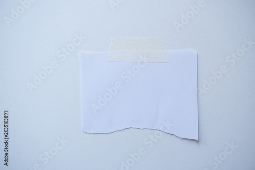 Tableau sur toile Blank torn white paper affixed to a soft background using beige masking tape, cr