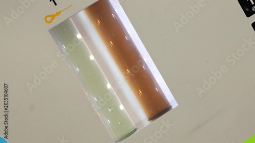 Clean and dirty oil passing through vials during automatic car transmission flush. 
