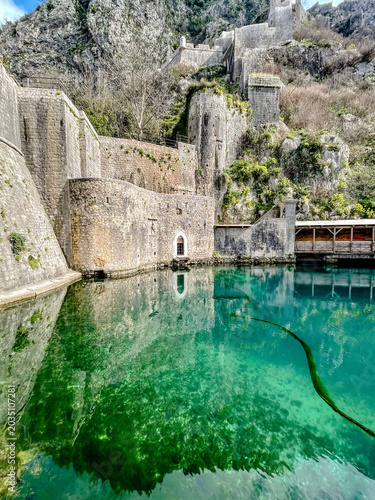 Bild auf Leinwand Ancient Kotor Fortress Beside Emerald Water
