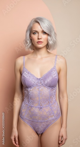 Beautiful young woman with silver hair posing in purple lace bodysuit lingerie