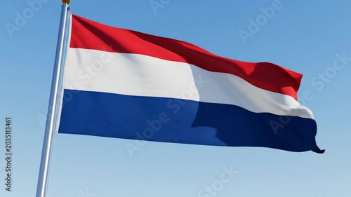 National flag of the netherlands waving against a clear blue sky