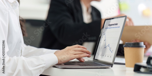 Obraz na płótnie Asian business woman analyzing data on laptop showing economic slowdown