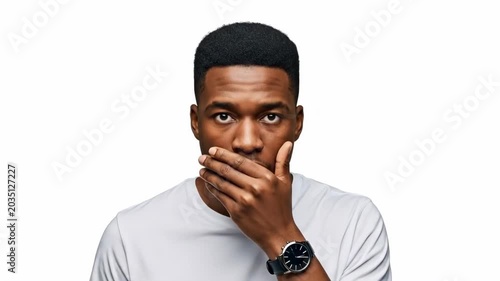 Surprised man covering his mouth in shock