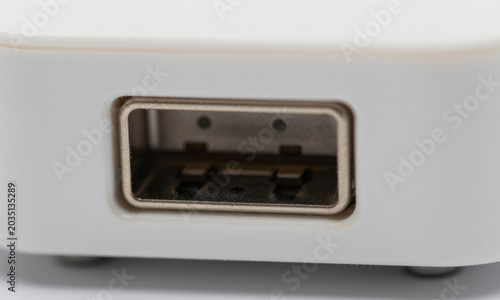 macro shot reveals scratched electronic device port bathed soft diffused light highlighting dusty usb connection intricate