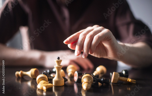 chess piece in female hands on a background