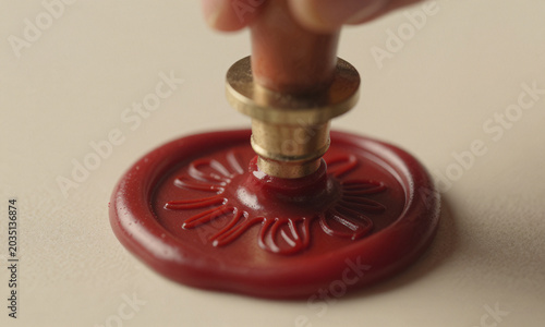 reveals vintage wax seal stamp pressing firmly molten red sealing wax capturing intricate detail soft golden