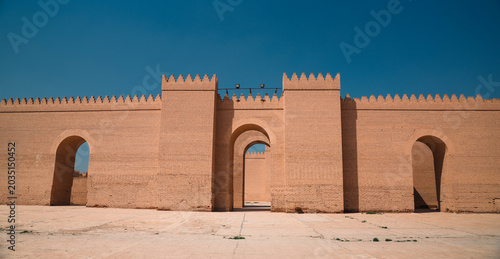 Exploring the ancient walls of Babylon in Iraq under clear blue sky