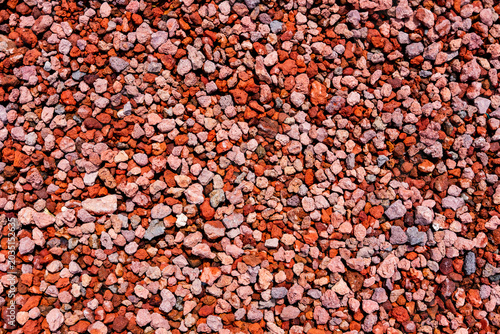 Obraz na plátně Red lava rock texture forming a natural background, volcanic scoria gravel patte