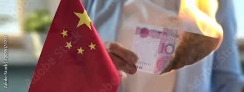 Foto Burning currency next to a China flag reflects economic tensions
