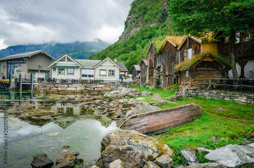 Old traditional houses on the coast of Geirangerfjord in town Geiranger, one of the most beautiful fjords in Norway