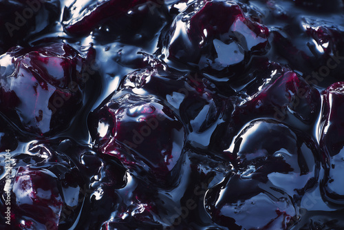 Macro texture of blueberry jam with ripe whole berries