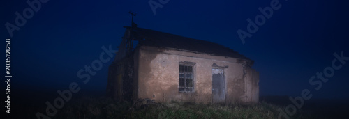 Canvas Print Abandoned house under cloudy twilight sky, moody atmosphere with soft fading light, evoking solitude, mystery, and quiet desolation in a rural landscape setting