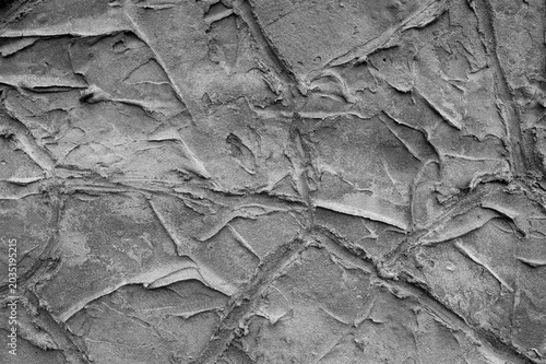 gray background, in the photo the texture of a gray wall with various lines, strokes and cracks