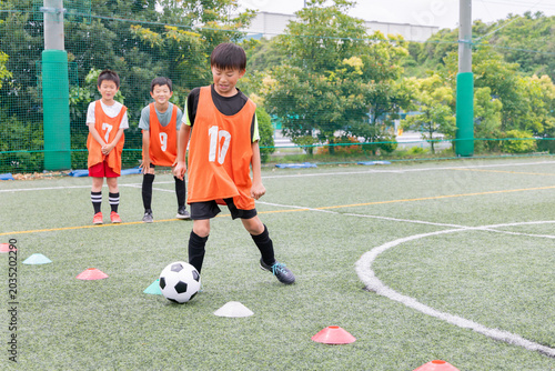 Photos ドリブル練習をする少年サッカー選手