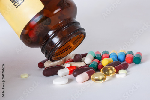 Photos substance abuse and overmedication, Multi colored capsules and tablets spilling