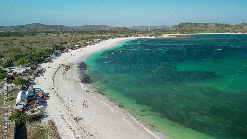 Fototapeta premium Aerial drone view Tanjung Aan Beach Lombok Indonesia featuring white sand turquoise bay hills and tropical coastal paradise