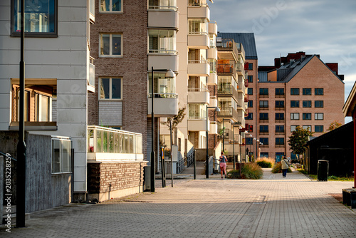 The modern district Malmö, people running on quiet afternoon, life on streets Sweden.