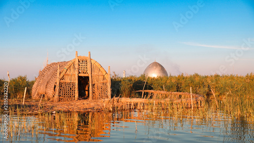 Tableau sur toile Traditional reed houses in the Mesopotamian Marshes in Iraq during a clear day