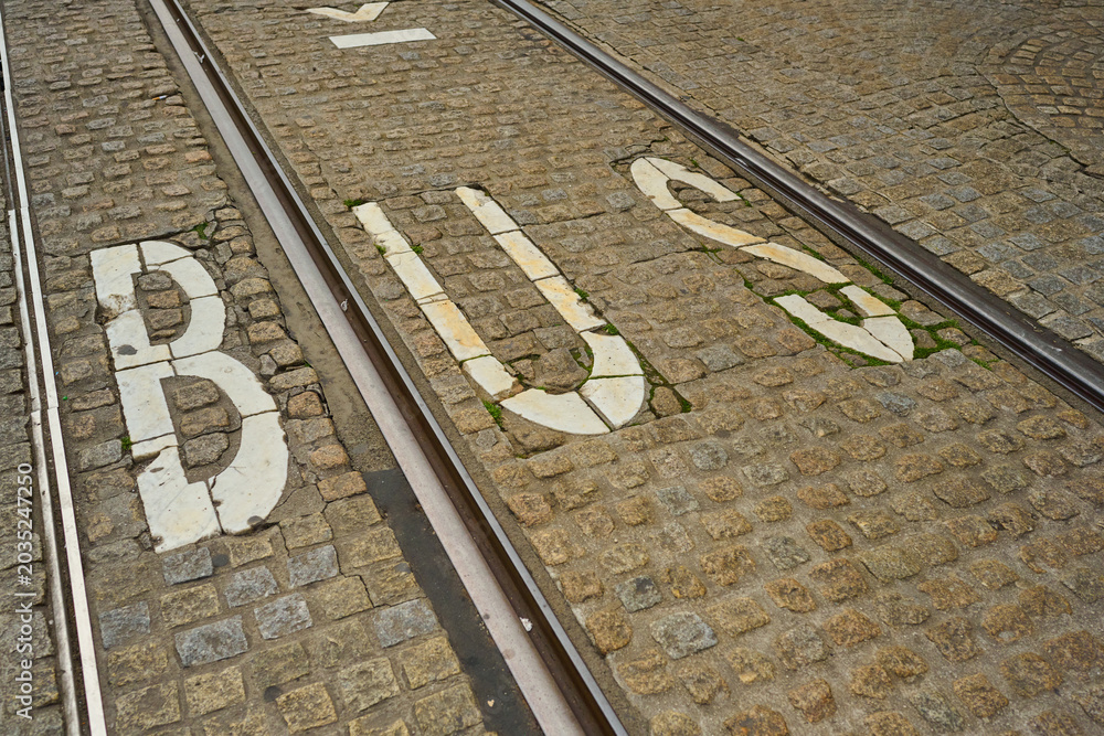 Fototapeta premium Cobblestone Streets in Amsterdam Reveal the Bustling Atmosphere of the City Center Highlighting Traffic and Transit