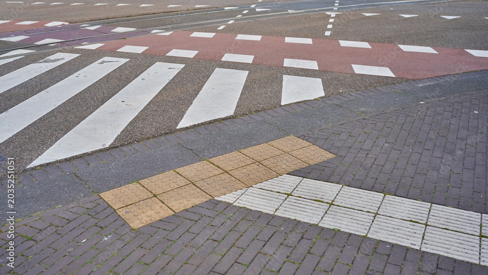 Fototapeta premium Stepping Across Colorful Crosswalks in the Vibrant Streets of Amsterdam's City Center During a Sunny Day