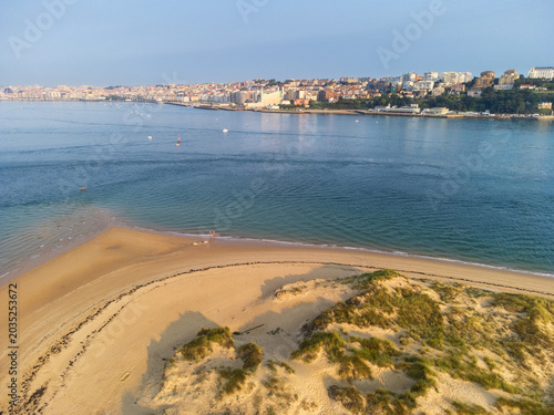 Bild auf Leinwand Aerial view of the tip of El Puntal spit with golden sand beaches and turquoise bay waters, with the city skyline of Santander visible in the distance