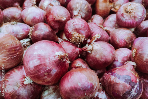 Fresh Red Onions and Shallots in a Farmers Market Heap for Healthy Cooking Background and Culinary Design Flexible Layout