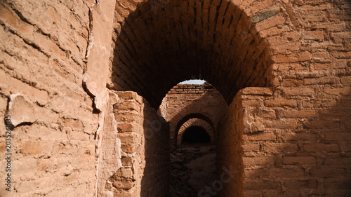 Exploring ancient brick arches in Iraq archaeological site at sunset