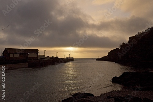 Sunrise above the Banjo pier Looe Cornwall,  just under a cloud Beyond paradise