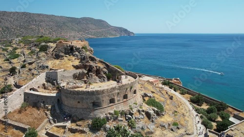 Aerial wide angle view of Spinalonga fortress walls and blue sea