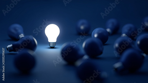 Bright illuminated light bulb surrounded by dark blue bulbs, standout idea, creative innovation, leadership vision, business success, inspiration and smart solution concept. bright