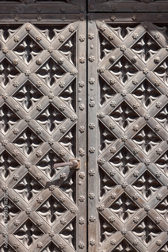 Metal decorative door of Gothic St. Bridget's Church built in 1514 , historic red brick basilica, Gdansk, Poland