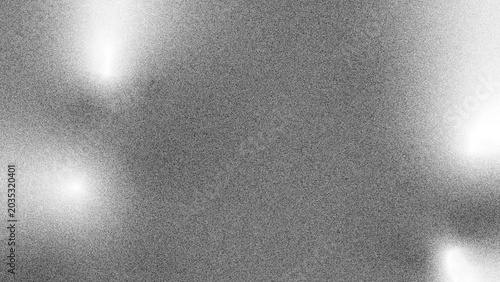 Abstract grayscale background with soft spotlight effects and granular texture.