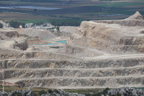 Panoramic View of an Open Pit Limestone Quarry with Mining Excavation Terraces