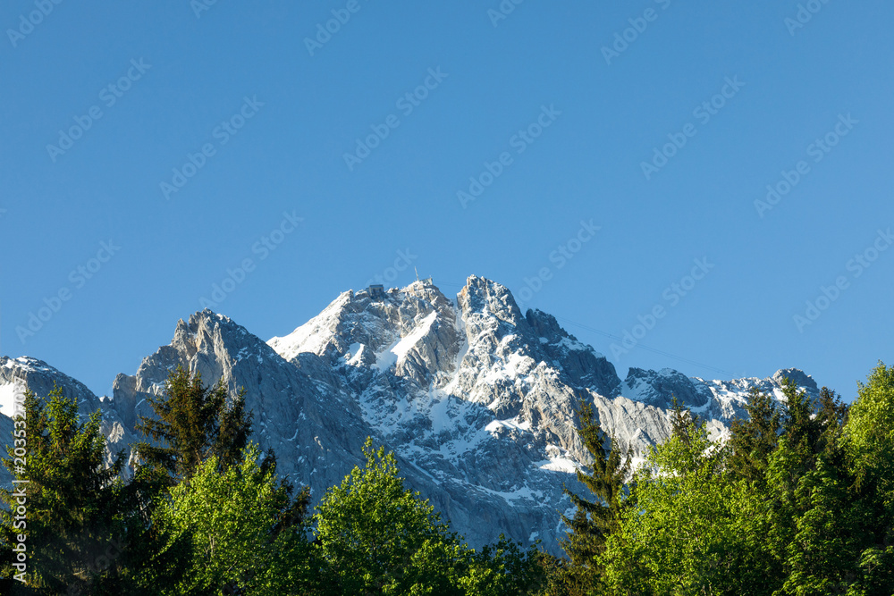 Obraz premium Travel landscape of Zugspitze Alps in Bavaria Germany, scenic summer nature panorama with forest, snow mountains peak